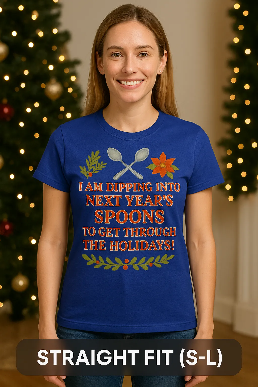 Shown on Straight Fit (S–L) body wearing royal blue T-shirt with 'I am dipping into next year's spoons to get through the holidays' unseen illness awareness design, standing in a cozy Christmas living room with holiday lights and wreath