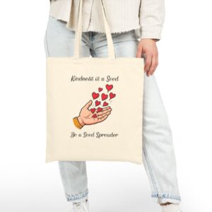 Kindness is a Seed Be a Seed Spreader Canvas Tote in Natural held by model