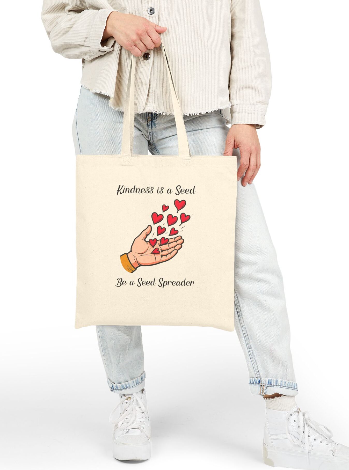 Kindness is a Seed Be a Seed Spreader Canvas Tote in Natural held by model