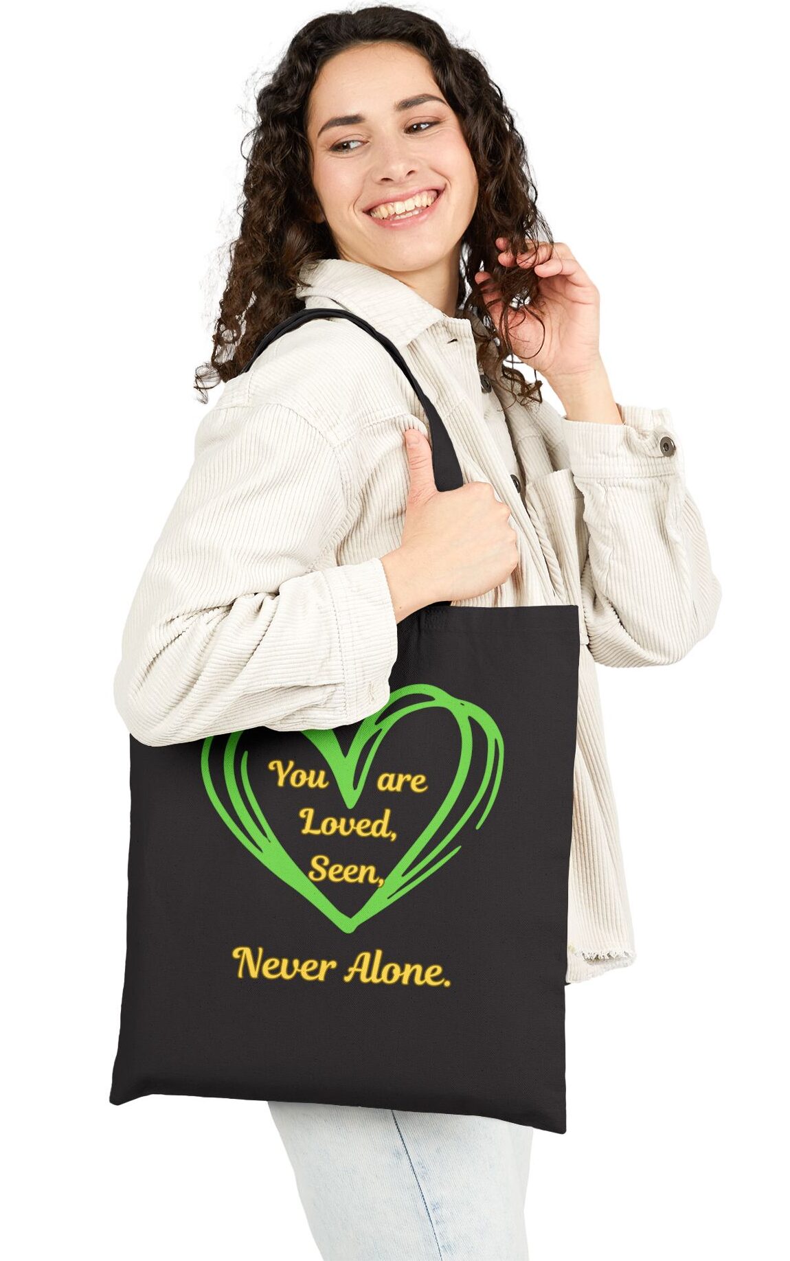 You are Loved, Seen, Never Alone Canvas Tote in Black held by female model