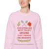 Dipping Into Next Year's Spoons Holiday Sweatshirt in Light Pink on female model