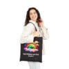God's Rainbow was First Canvas Tote Bag in Black on shoulder of female model