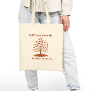 Fall Trees Show Us it is Okay to Let Go Canvas Tote in Natural held by female model