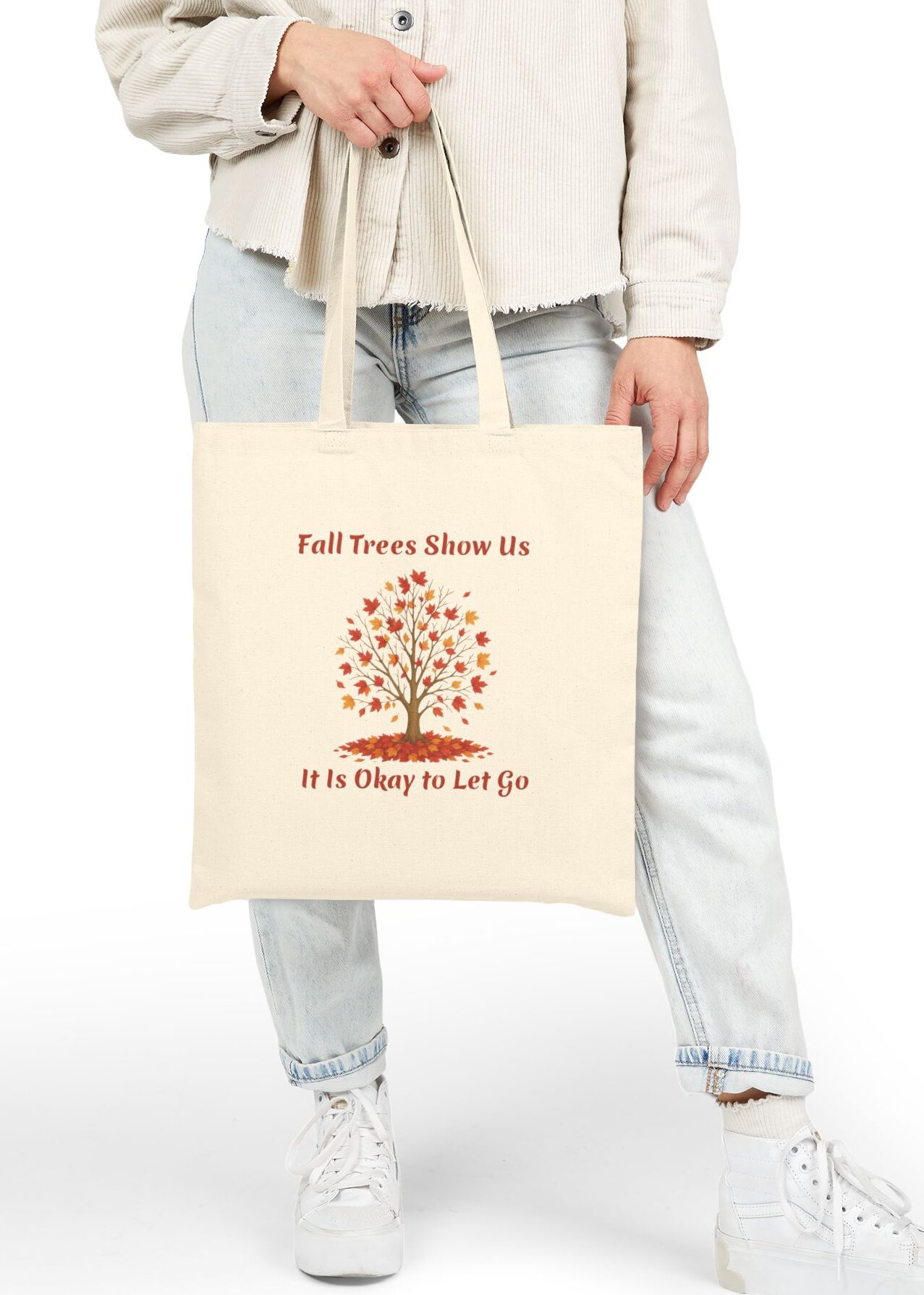 Fall Trees Show Us it is Okay to Let Go Canvas Tote in Natural held by female model