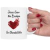 "Jesus Saw the Broken Hearted" Ceramic Mug held by a woman's hand
