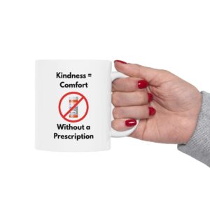 "Kindness = Comfort" Ceramic Mug held by woman's hand