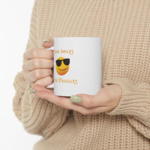 "Some Smiles Hide Struggles" Ceramic Mug held in woman's hands