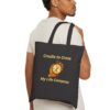 “Cradle to Cross / My Life Compass.” Tote Bag in Black held by male model