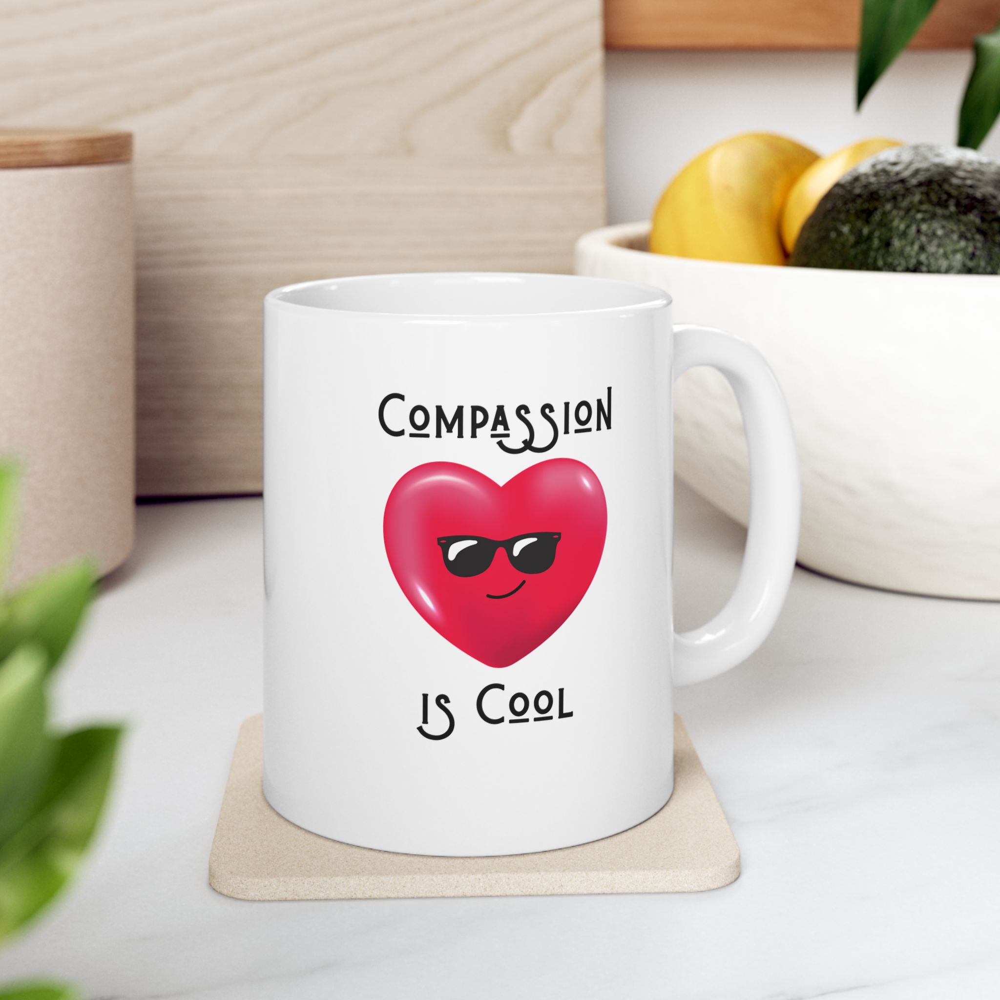 "Compassion is Cool" Ceramic Mug on kitchen counter