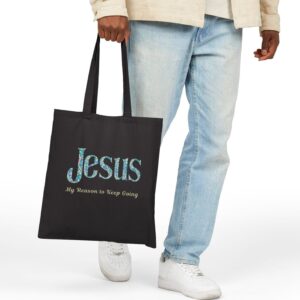“Jesus – My Reason to Keep Going” Canvas Tote in Black being held by male model