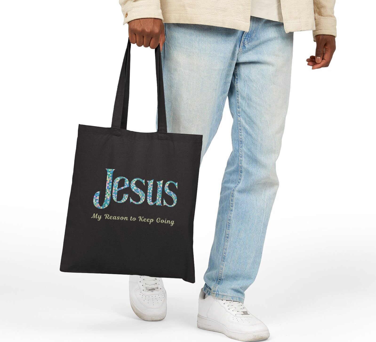 “Jesus – My Reason to Keep Going” Canvas Tote in Black being held by male model