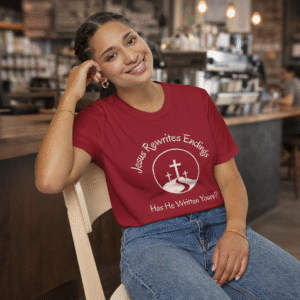 Jesus Rewrites Endings Short Sleeve Tee in Cardinal Red on woman sitting in coffee shop